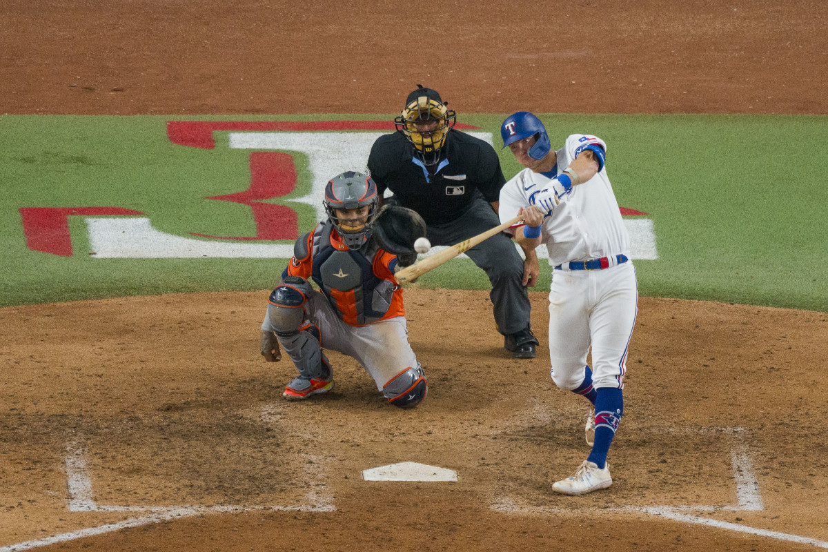 Oct 18, 2023; Arlington, Texas, USA; Texas Rangers third baseman Josh Jung (6) hits a two run home run against the Houston Astros during the seventh inning during game three of the ALCS for the 2023 MLB playoffs at Globe Life Field. Mandatory Credit: Jerome Miron-USA TODAY Sports
